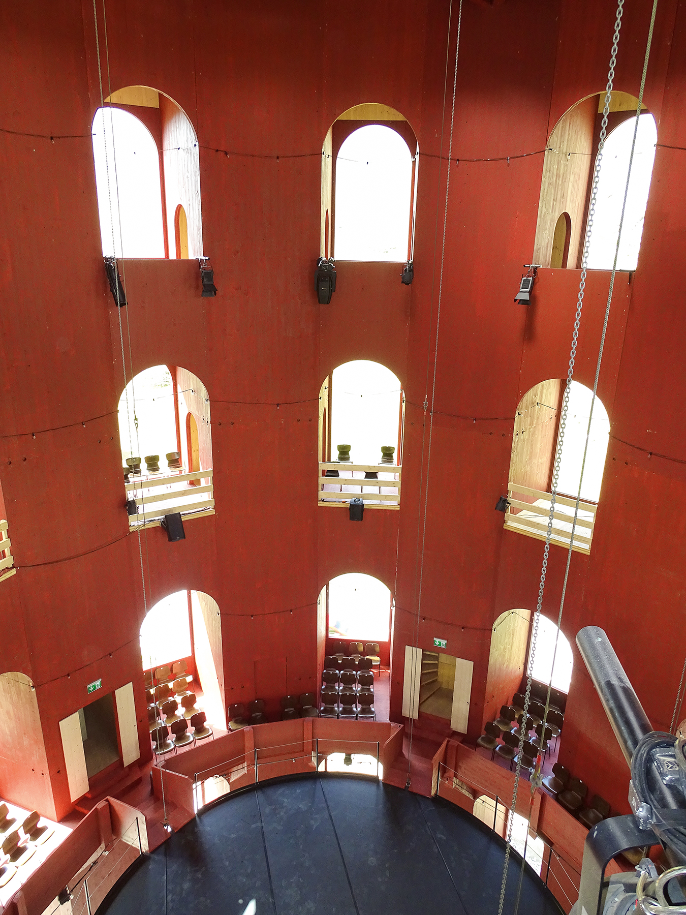 Das Publikum sitzt in den übereinander getürmten Logen. Die höhenverstellbare Bühne hängt an Ketten.