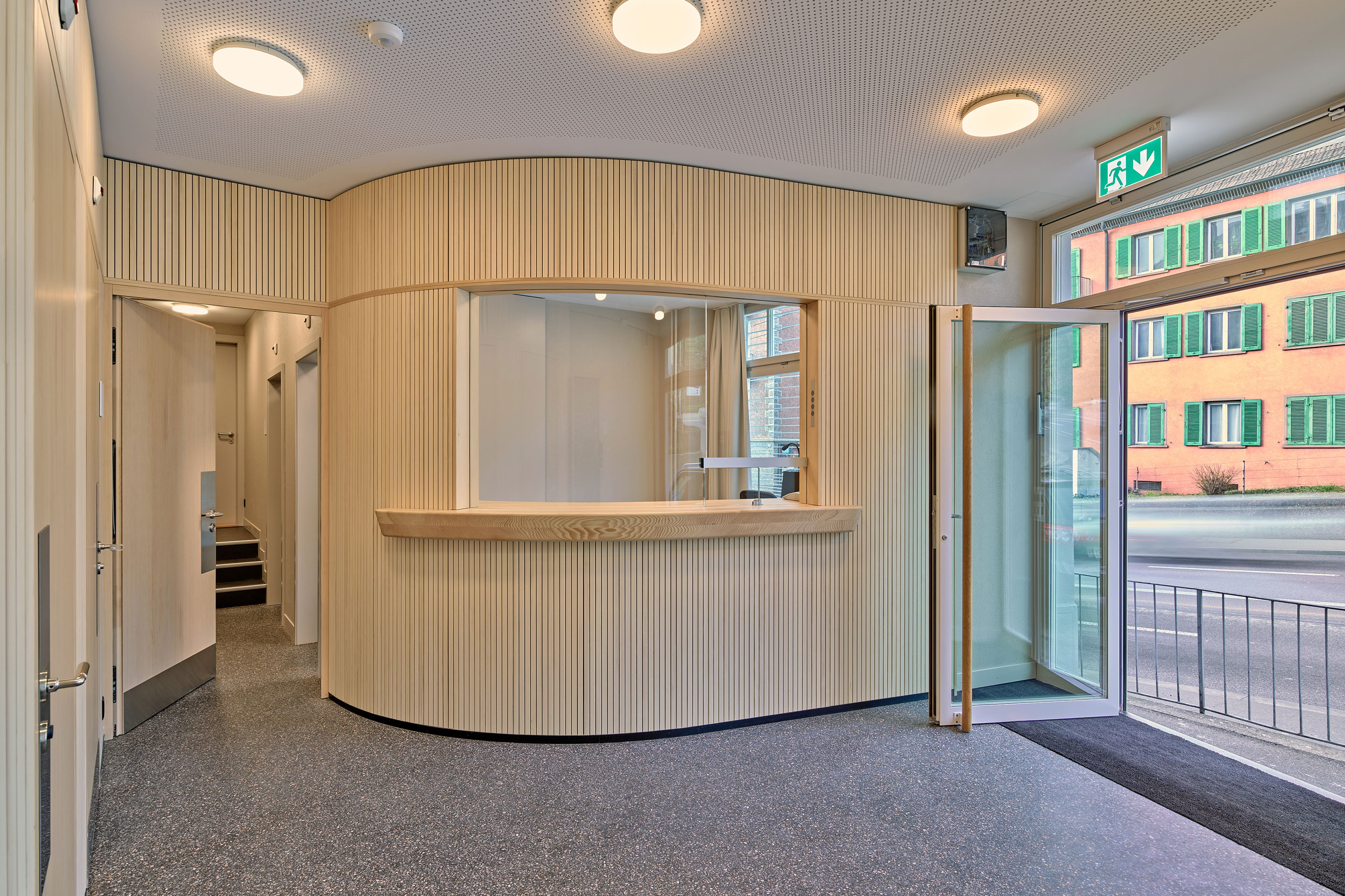 Bereits am Empfang wird klar, dass die umgebaute Notschlafstelle möglichst licht und offen gestaltet sein soll, anstatt Besuchende mit pflegeleichter Sterilität zu umhüllen.