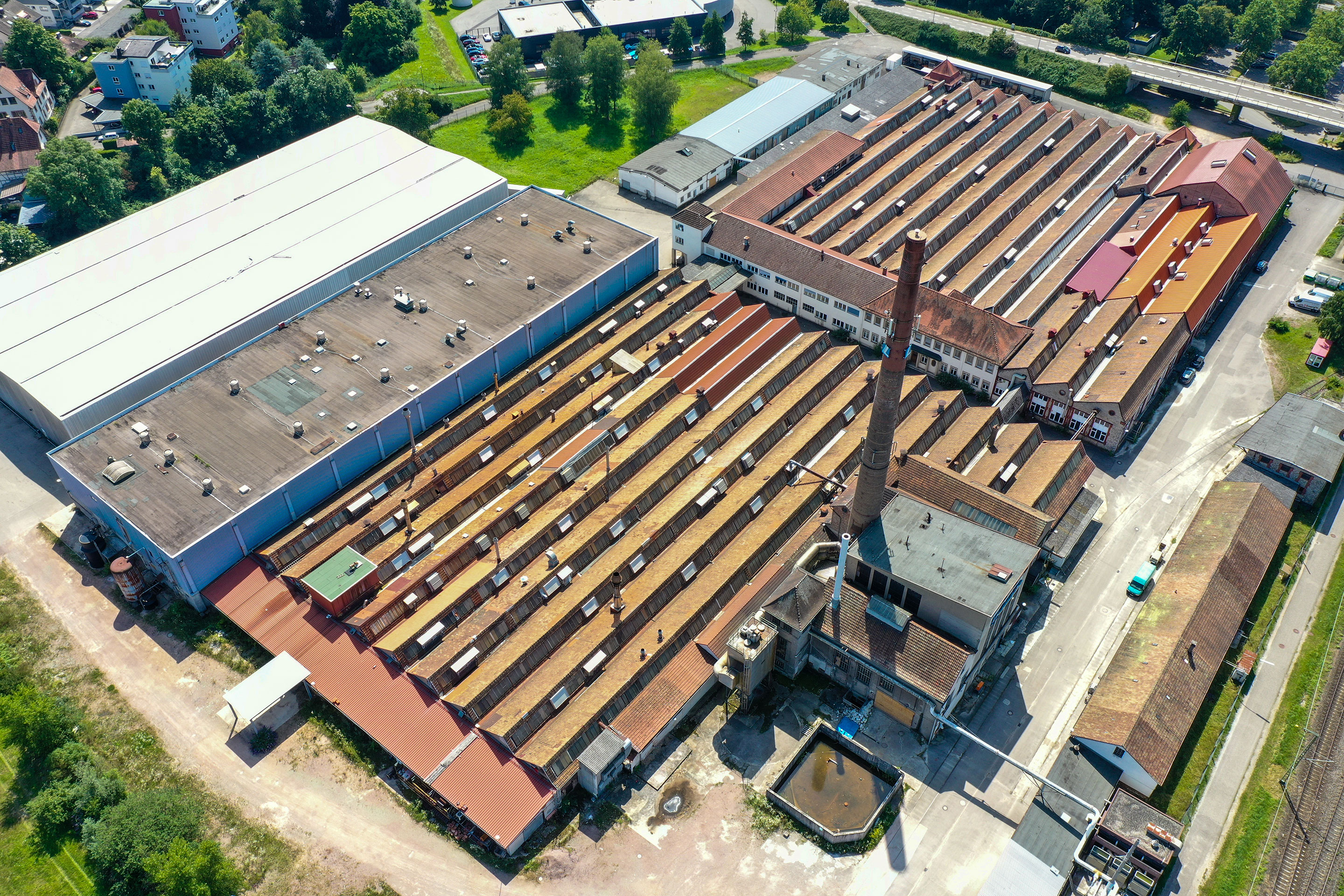 Auf dem Gelände der Lauffenmühle fallen die historischen Fabrikgebäude auf: «Unter Denkmalschutz stehen die Gebäude und ihre Fassaden nicht. Doch wir möchten diese ortsbildprägenden Elemente instand setzen und in ihrer Grundstruktur soweit möglich erhalten“; sagt Alexander Nöltner, Fachbereichsleiter Stadtplanung bei der Stadt Lörrach und Projektleiter «Lauffenmühle – next innovation».