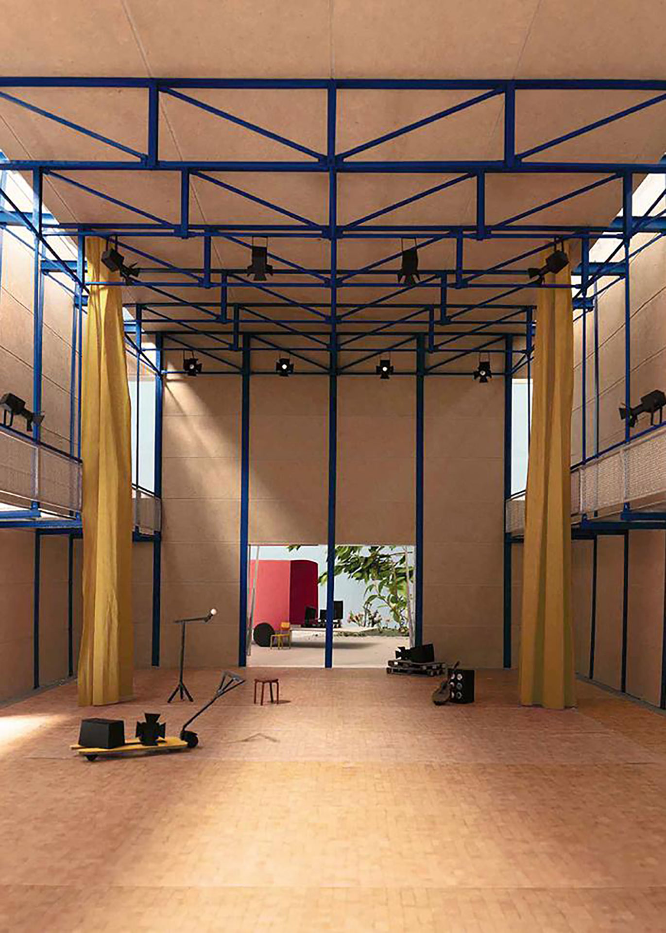 Der neue Mehrzwecksaal, der aus wiederverwendeten Stahlelementen und Lehmwänden besteht, bietet eine schlichte Atmosphäre, die an die Welt des Theaters erinnert.