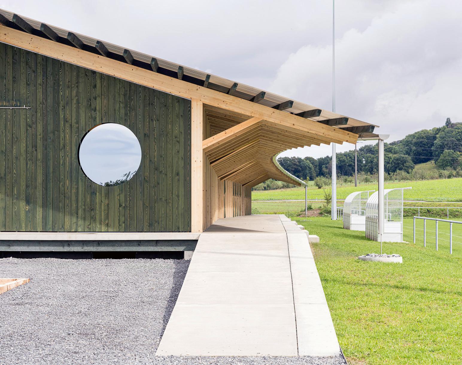 The walkway serving the pavilion offers the public a bench sheltered from the sun.