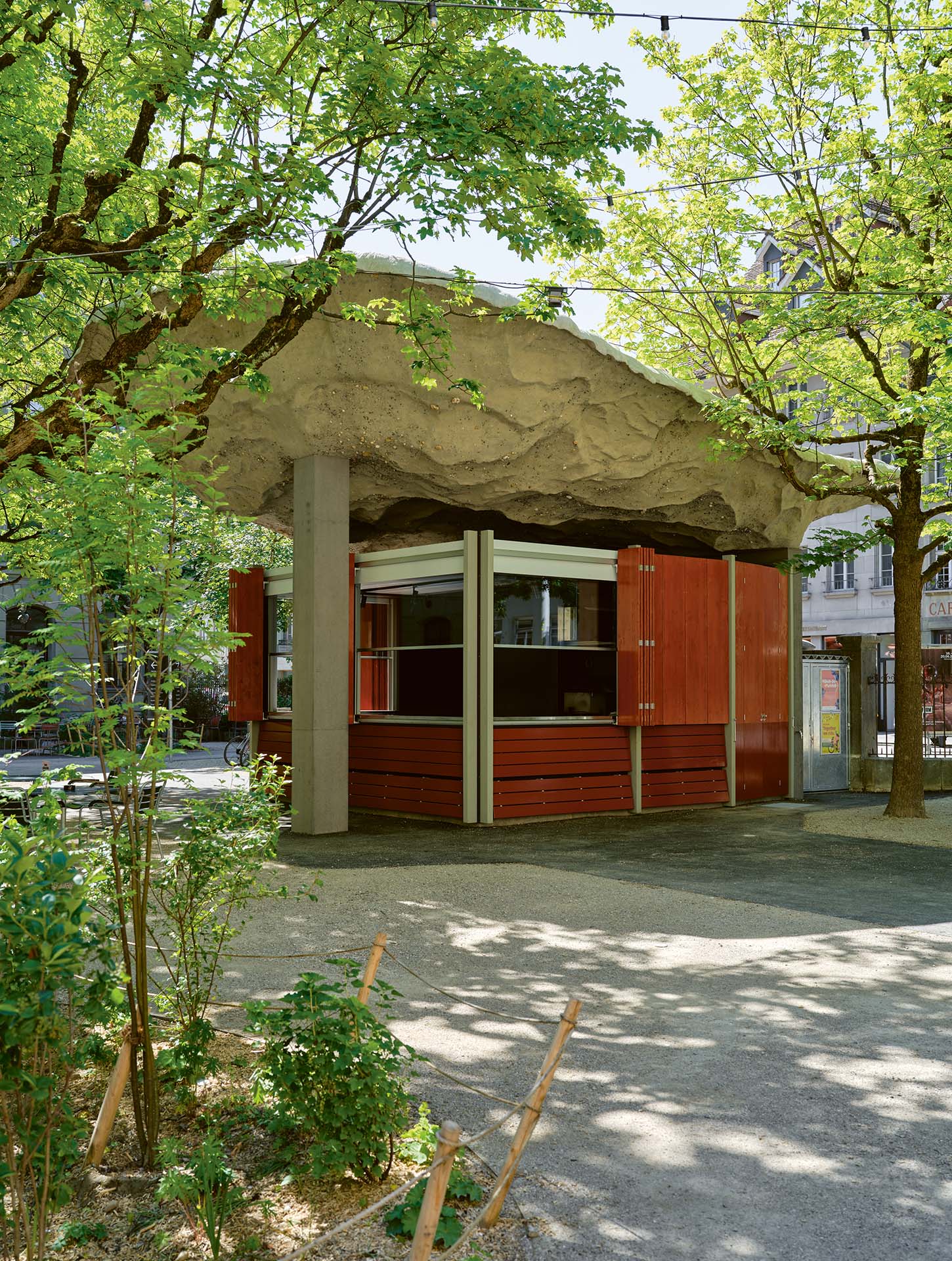 Eine monumentale Betonskulptur schwebt als Dach über der neuen Aussenbar, die sich auf drei Seiten öffnen lässt.