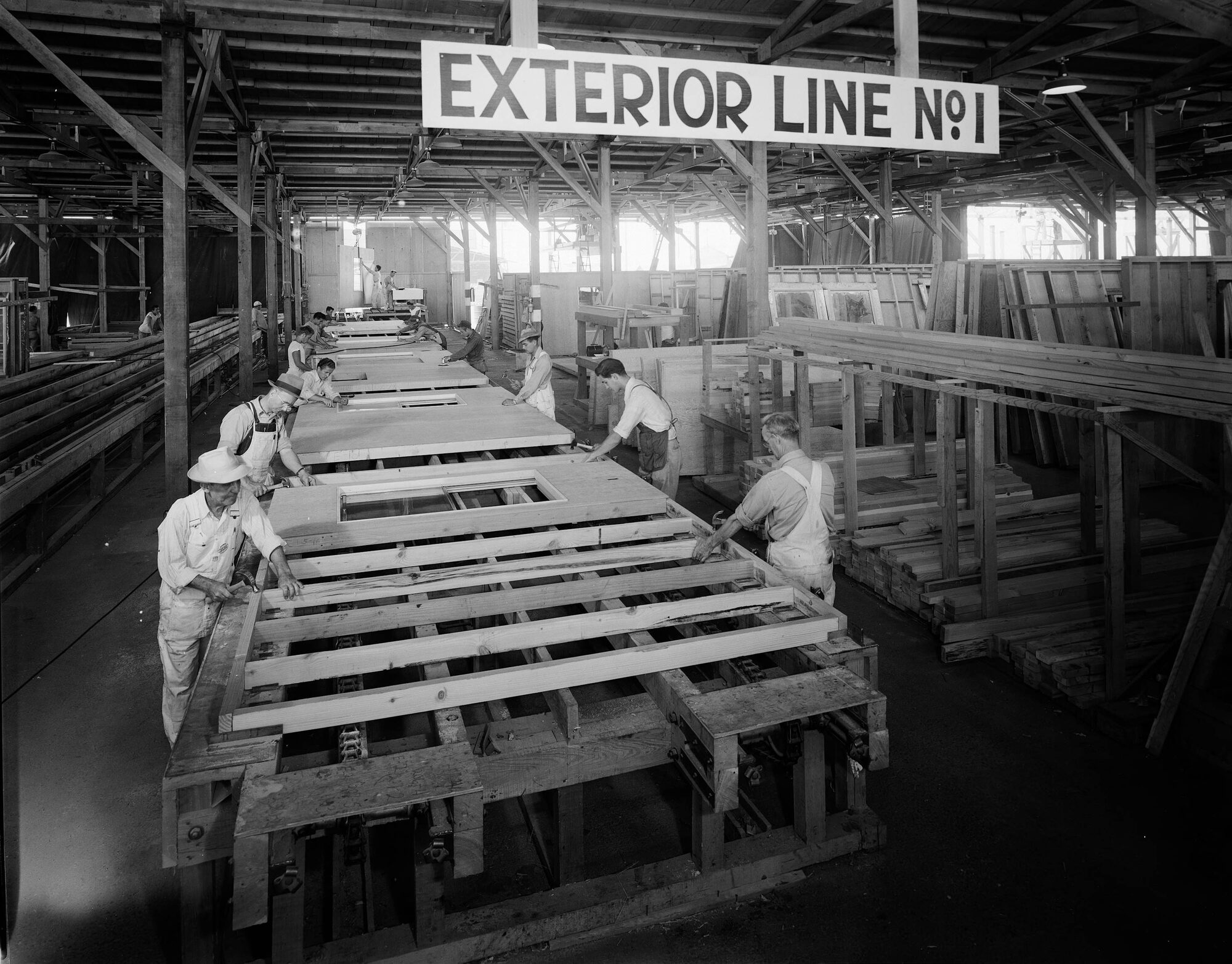 Ouvriers assemblant des murs préfabriqués dans un entrepôt, Kaiser Community Homes, Los Angeles, 1946