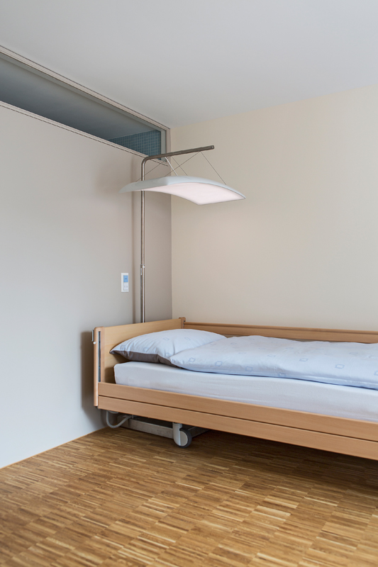 Prototyp der Dämmerungssimulationsleuchte für die Stiftung Hofmatt, Münchenstein. Wichtig für die therapeutische Wirkung ist der ausladende Schirm. So wird sichergestellt, dass ausreichend Licht zu den Nutzern gelangt. Mit einer separaten Handsteuerung können die gewünschten Aufwach- und Zubettgehzeiten auf die Leuchte übertragen werden. Tagsüber kann die Leuchte als Leselicht dienen.