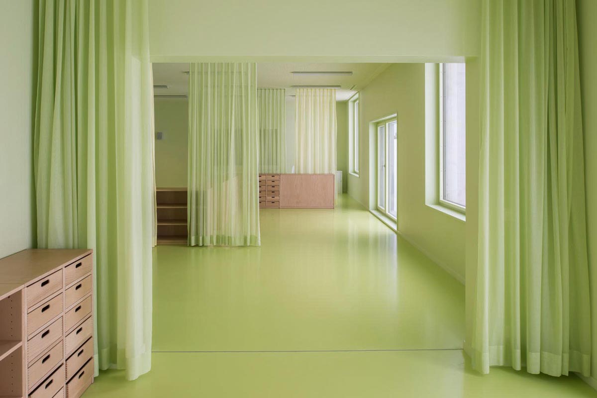 Die Räume des Kindergartens sind in Hellgrün gehalten. Vorhänge dienen der Zonierung (Wand und Decke: NCS S 1020-G60Y; Boden: NCS S 1040-G60Y).