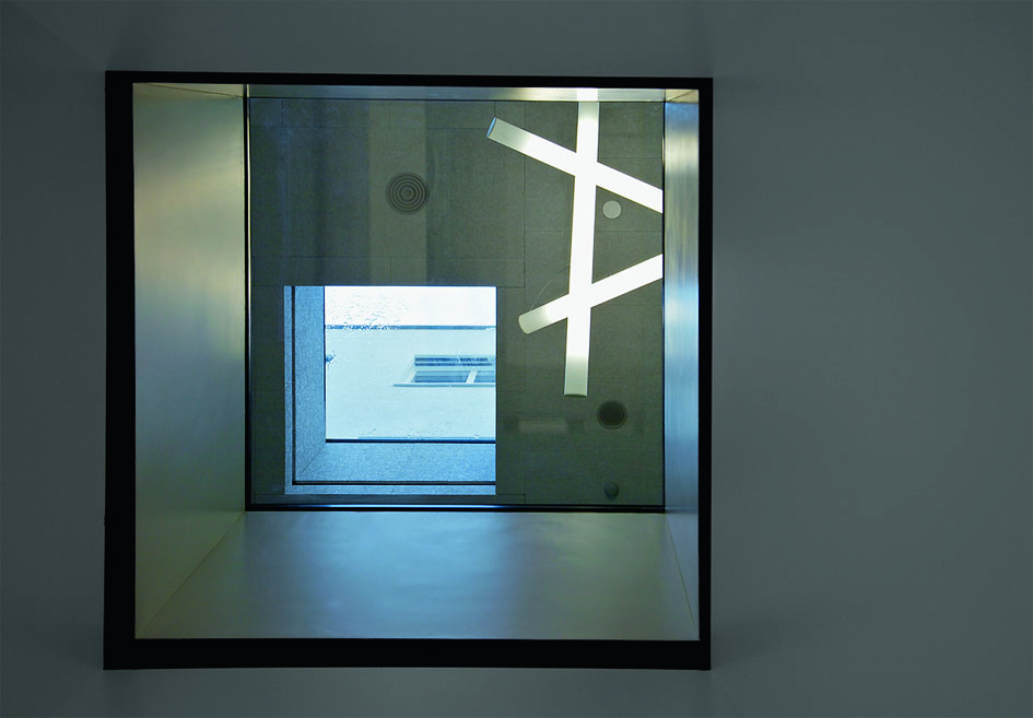 Natürliches Licht fällt über die in den Lichthof eingeschnittenen Oberlichter des Bibliothekslesesaals bis in den grossen Hörsaal «vermittelt» über die Oberlichter, die in die Tische im Lesesaal eingelassen sind. Hier der Blick von unten nach oben